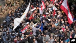 Retired army soldiers and other protesters who are demanding better pay, clashes with Lebanese army and riot police, in Beirut, Lebanon, March 22, 2023. 
