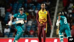 New Zealand's Finn Allen, left, runs between the wickets during the men's T20 World Cup cricket match between the West Indies and New Zealand at the Brian Lara Cricket Academy, Tarouba, Trinidad and Tobago, June 12, 2024.