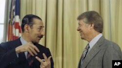 FILE - President Jimmy Carter with Jorge R. Videla, president of Argentina, at the White House, Sept. 9, 1977.