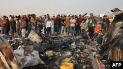Palestinians gather at the site of an Israeli strike on a camp for internally displaced people in Rafah on May 27, 2024. 