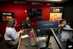 From left, guest Carolina Rodriguez-Greer with Mi Familia Vota, host Osvaldo Franco and engineer Daniel Orona broadcast from the Phoenix studio of Radio Campesina, a Spanish-language network, March 20, 2024.