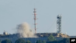 Smoke rises from inside an Israeli army position that was hit by Hezbollah fighters as seen from Tair Harfa village, a Lebanese border village with Israel in south Lebanon, Oct. 20, 2023.