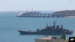 FILE - A Russian military landing ship, which now transports cars and people between Crimea and Taman because the Crimean Bridge is closed, sails not far from Kerch, Crimea, July 17, 2023.