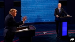 FILE - Then-President Donald Trump answers a question as Democratic presidential candidate Joe Biden listens during the second and final presidential debate, Oct. 22, 2020, at Belmont University in Nashville, Tennessee.