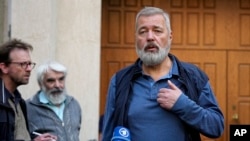 FILE - Nobel Peace Prize laureate Dmitry Muratov, editor-in-chief of the influential Russian newspaper Novaya Gazeta speaks to journalists outside a court in Moscow, Russia, June 8, 2023.