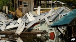 A home that came off its blocks sits partially submerged in a canal, in Horseshoe Beach, Fla., Sept. 1, 2023, two days after the passage of Hurricane Idalia.