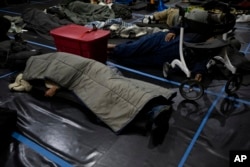 People rest at Friendly House which opened as an emergency warming shelter, Jan. 13, 2024, in Portland, Oregon.