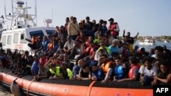 Migrants arrive in the harbor of Italian island of Lampedusa, Sept. 18, 2023.
