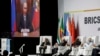 Presiden Rusia Vladimir Putin (tampak di layar monitor) memberikan pidato di KTT BRICS melalui rekaman video, Selasa (22/8).