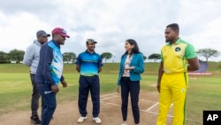 Britain's Home Secretary Suella Braverman speaks to players during a visit to the Gahanga International Cricket Stadium, Kigali, Rwanda, March 19, 2023.