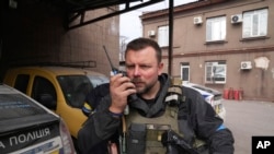 FILE -Mikhailo Vershinin, head of Mariupol's Police Patrol speaks by a radio on his base in Mariupol, Ukraine, March 15, 2022.