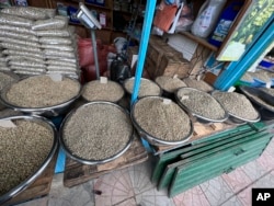 Several types of coffee beans are laid out for sale at Sholla Market, an outdoor flea market, in Addis Ababa, Ethiopia on Wednesday, Aug. 16, 2023. (AP Photo/Almaz Abedje)