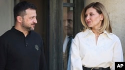 FILE - Ukrainian President Volodymyr Zelenskyy and his wife Olena Zelenska look at each other during a visit to the Elysee Palace in Paris, France, June 7, 2024.