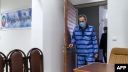 FILE - Jamshid Sharmahd, who is accused by the Iranian government of being a leader of the US-based "Tondar terrorist group" behind a deadly attack in Iran in 2008, arrives to attend the first hearing of his trial in the capital Tehran on Feb. 6, 2022. 