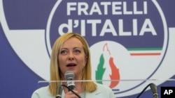 FILE - Far-right party Brothers of Italy's leader Giorgia Meloni speaks to the media at her party's electoral headquarters in Rome, Sept. 26, 2022.