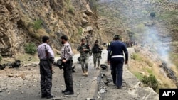 File - Security personnel inspect the site of a suicide attack near Besham city, Shangla district of Khyber Pakhtunkhwa province, March 26, 2024. Five Chinese nationals working on a dam construction site were killed when a suicide bomber targeted their vehicle.
