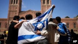 Pro-Israeli demonstrators gather near a Pro-Palestinian encampment on the UCLA campus April 25, 2024, in Los Angeles.