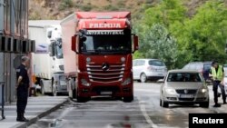 FILE - A police officer stands at the Kosovo-Serbia border crossing, in Jarinje, Kosovo, June 15, 2023.