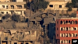 FILE - Destroyed houses in Khiam, a town near the Lebanese-Israeli border, that was hit by Israeli air strikes on Friday June 21, seen from the Lebanese town of Marjayoun, Lebanon, June 22, 2024.