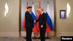 Chinese President Xi Jinping and Russian President Vladimir Putin attend a meeting on the sidelines of the Shanghai Cooperation Organization summit in Astana, Kazakhstan, on July 3, 2024. (Sputnik via Reuters)