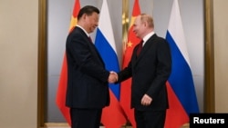 Chinese President Xi Jinping and Russian President Vladimir Putin attend a meeting on the sidelines of the Shanghai Cooperation Organization summit in Astana, Kazakhstan, July 3, 2024. (Sputnik via Reuters)