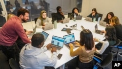 Slade Sohmer, standing left, editor at the news video company Recount, conducts a workshop for reporters at The News Movement (TNM), a social media news operation re-imagined for Gen-Z consumers, March 1, 2023, in New York. 