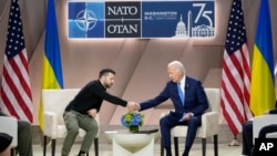 President Joe Biden, right, shakes the hand of Ukraine's President Volodymyr Zelenskyy during a meeting on the sidelines of the NATO Summit in Washington, July 11, 2024. 
