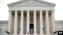FILE - Police office guards the main entrance to the Supreme Court in Washington, Oct. 9, 2018.