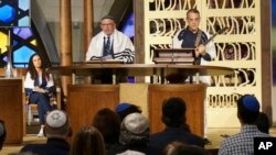 Senior Rabbi Gayle Pomerantz (seated, left), Rabbi Robert Davis and Cantor Juval Porat lead Shabbat services at Temple Beth Sholom in Miami Beach, Fla., Oct. 13, 2023.