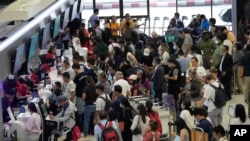 Passengers line up for check in at Don Mueang International Airport in Bangkok, Thailand, July 19, 2024. 
