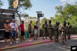 Israeli security forces are seen deployed at the site of a shooting attack in the West Bank Israeli settlement of Ma'ale Adumim, Aug 1, 2023.