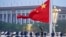 FILE - A Chinese honor guard unfurls the Chinese national flag at ceremony marking the 73rd anniversary of the founding of the People's Republic of China, in Beijing, Oct. 1, 2022.