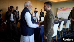 FILE - Ukraine's President Volodymyr Zelenskyy, right, and Indian Prime Minister Narendra Modi shake hands during the G7 leaders' summit in Hiroshima, Japan, May 20, 2023. (Ukrainian Presidential Press Service/Handout via Reuters)