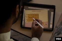 Young artist is seen drawing illustrations on his Tablet in Srinagar neighborhood of Srinagar. He has refrained from publishing his work due to fear. (Wasim Nabi/VOA)