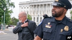 Special Counsel John Durham, left, leaves a closed hearing of the Permanent Select Committee on Intelligence, June 20, 2023, on Capitol Hill in Washington.