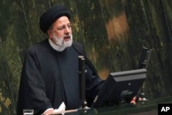 FILE - Iranian President Ebrahim Raisi addresses lawmakers at the parliament in Tehran, Iran, Jan. 22, 2023.