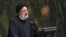 FILE - Iranian President Ebrahim Raisi addresses lawmakers at the parliament in Tehran, Iran, Jan. 22, 2023. 