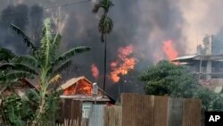 FILE - In this image made from video, smoke rises from burning houses in Manipur, India, May 28, 2023.