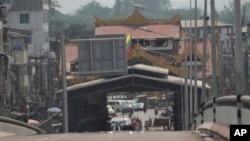 People gather at a checkpoint near the 1st Thai-Myanmar Friendship Bridge in Myawaddy district in eastern Myanmar, April 12, 2024. 