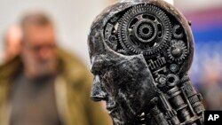 FILE - A metal head made of motor parts symbolizes AI, at the Essen Motor Show in Essen, Germany, Nov. 29, 2019. Efforts to come up with rules to ensure AI's trustworthiness come as governments worldwide are exploring the impact of the technology.