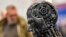 FILE - A metal head made of motor parts symbolizes AI, at the Essen Motor Show in Essen, Germany, Nov. 29, 2019. Efforts to come up with rules to ensure AI's trustworthiness come as governments worldwide are exploring the impact of the technology.