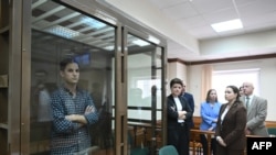 US journalist Evan Gershkovich stands inside a defendants' cage before a hearing to consider an appeal on his arrest at the Moscow City Court in Moscow, Apr. 18, 2023. 