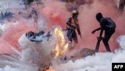 FILE - A tear gas canister explodes in downtown Nairobi as protesters try to help injured people outside the Kenya Parliament during a strike to protest tax hikes and the 2024 finance bill. After the protests, Kenya experienced a nationwide loss in internet connectivity. 