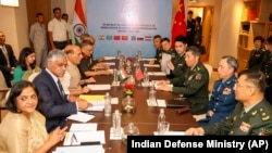 Indian Defense Minister Rajnath Singh, 3rd left, attends a meeting with his Chinese counterpart Li Shangfu, 3rd right, during the Shanghai Cooperation Organization Defense Minister's Meeting in New Delhi, April 27, 2023.