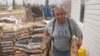 Arthur John, a retired trapper, carries firewood to his home Thursday, Sept. 23, 2021 in the Native Village of Tanacross, Alaska. COVID of robbed him of the lifestyle he so enjoyed, such as using a chainsaw to chop enough wood to heat their house through winter. 