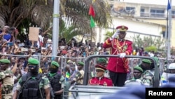 Gabon coup leader General Brice Oligui Nguema waves after being sworn in as interim president during his swearing-in ceremony, in Libreville, Gabon, Sept. 4, 2023. 
