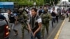 Soldiers and police provide security behind an armored vehicle as supporters of presidential candidate Daniel Noboa, of the National Democratic Action Alliance political party, attend a rally with their candidate in downtown Esmeraldas, Ecuador, Oct. 6, 2023. 