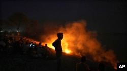 People cremate their relatives who have died from heat-related illnesses, in Ballia, in northern Indian state of Uttar Pradesh, June 19, 2023.