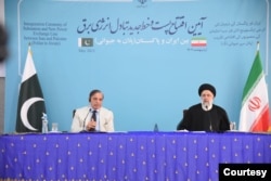 Iran's President Ebrahim Raisi and Pakistan Prime Minister Shehbaz Sharif jointly inaugurate a market and power transmission line, along their shared border, May 18, 2023. (Photo courtesy of Sharif office)