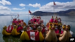 Aymara Indigenous women from the Uros floating islands arrive in Puno, Peru, via boats on Lake Titicaca, March 8, 2023. The lake is one of many of the world's most important water sources that has lost water at a cumulative rate of about 22 gigatonnes per year for nearly three decades, according to a study published on Thursday.